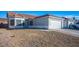 Front yard view of a single-story house with gravel landscaping and a two-car garage at 2594 Florida Keys Dr, Las Vegas, NV 89156