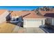 Single-story house with tile roof, two-car garage, and desert landscaping at 2594 Florida Keys Dr, Las Vegas, NV 89156