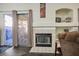 Gas fireplace with tile surround and sliding glass door access to backyard at 2594 Florida Keys Dr, Las Vegas, NV 89156