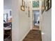 Bright hallway with dark wood floors and framed Gathering photos at 2594 Florida Keys Dr, Las Vegas, NV 89156