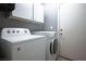 Laundry room with washer, dryer, and overhead cabinets at 2594 Florida Keys Dr, Las Vegas, NV 89156