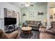 Living room with wood-look floors, neutral walls, and comfy seating at 2594 Florida Keys Dr, Las Vegas, NV 89156