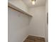 Walk-in closet with wood shelving and a hanging rod at 350 E Desert Inn Rd # H208, Las Vegas, NV 89109
