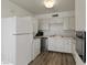 Updated kitchen featuring stainless steel appliances and wood flooring at 350 E Desert Inn Rd # H208, Las Vegas, NV 89109
