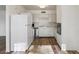 Kitchen with white cabinets, modern appliances, and wood-look floors at 350 E Desert Inn Rd # H208, Las Vegas, NV 89109