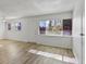 Living room with large windows, wood-look floors, and a ceiling fan at 350 E Desert Inn Rd # H208, Las Vegas, NV 89109