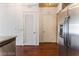 Hallway with wood flooring, white louvered door and entry door at 353 E Bonneville Ave # 711, Las Vegas, NV 89101
