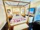Spacious bedroom with a wooden canopy bed and a large TV at 3550 Bay Sands Dr # 1070, Laughlin, NV 89029