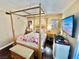 Spacious bedroom with a wooden canopy bed and a large TV at 3550 Bay Sands Dr # 1070, Laughlin, NV 89029