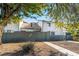 Private backyard with a gray fence and a walkway leading to the back door at 4071 Village Sq, Las Vegas, NV 89121