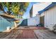 Private backyard with patio, storage and a partially visible wood pile at 4071 Village Sq, Las Vegas, NV 89121
