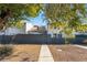 Private backyard with a gray fence and a walkway leading to the back door at 4071 Village Sq, Las Vegas, NV 89121