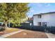 Private backyard with a gray fence and a walkway leading to the back door at 4071 Village Sq, Las Vegas, NV 89121
