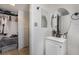 Bathroom with white vanity, round mirror, and closet at 4071 Village Sq, Las Vegas, NV 89121