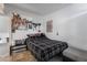 Comfortable bedroom with a plaid comforter and anime posters at 4071 Village Sq, Las Vegas, NV 89121