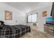 Cozy bedroom with a plaid comforter and large TV at 4071 Village Sq, Las Vegas, NV 89121
