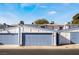 Front view of a townhouse with a two-car garage and blue doors at 4071 Village Sq, Las Vegas, NV 89121