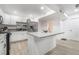 Bright kitchen featuring white shaker cabinets, a large island, and stainless steel appliances at 4071 Village Sq, Las Vegas, NV 89121