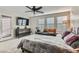 Main bedroom with large windows, a dresser and a ceiling fan at 495 Granite Arch St, Las Vegas, NV 89138