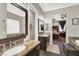 Double sink bathroom with granite countertops and a view to the bedroom at 7036 Winstar St # A, Las Vegas, NV 89131