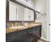 Bathroom with granite countertop, double sinks, and large mirror at 7036 Winstar St # A, Las Vegas, NV 89131