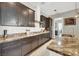 Gourmet kitchen with dark wood cabinets and granite countertops at 7036 Winstar St # A, Las Vegas, NV 89131
