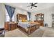 Spacious main bedroom with a king-size bed, ornate furniture, and ceiling fan at 7036 Winstar St # A, Las Vegas, NV 89131