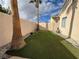 Landscaped backyard with artificial turf and palm trees at 8545 Summer Vista Ave, Las Vegas, NV 89145