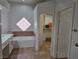 Elegant bathroom with soaking tub, walk-in closet, and marble vanity at 8545 Summer Vista Ave, Las Vegas, NV 89145