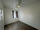 Bright bedroom with ceiling fan and wood-look floors at 8545 Summer Vista Ave, Las Vegas, NV 89145