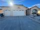 Single-story house with three-car garage and desert landscaping at 8545 Summer Vista Ave, Las Vegas, NV 89145