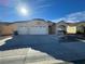 Single-story house with three-car garage and landscaped front yard at 8545 Summer Vista Ave, Las Vegas, NV 89145