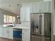 Modern kitchen with white cabinets, stainless steel appliances, and quartz countertops at 8545 Summer Vista Ave, Las Vegas, NV 89145