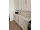 White kitchen cabinets and quartz countertops offer ample storage and prep space at 8545 Summer Vista Ave, Las Vegas, NV 89145