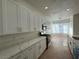 Bright kitchen featuring white cabinets, stainless steel appliances, and a spacious layout at 8545 Summer Vista Ave, Las Vegas, NV 89145