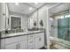 Elegant bathroom with double sinks, granite counters, and a glass shower at 9321 January Dr, Las Vegas, NV 89134