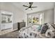 Airy bedroom featuring a bay window, ceiling fan and adjacent bathroom at 9321 January Dr, Las Vegas, NV 89134
