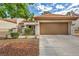 Front view of a single-story house with a garage and desert landscaping at 9321 January Dr, Las Vegas, NV 89134