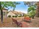 Exterior of home has inviting benches surrounded by lush trees in a serene setting at 9321 January Dr, Las Vegas, NV 89134