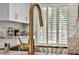 Close-up of a kitchen sink with a gold faucet and granite countertop at 9321 January Dr, Las Vegas, NV 89134