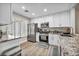Bright kitchen featuring white cabinetry, stainless steel appliances, and plank flooring at 9321 January Dr, Las Vegas, NV 89134