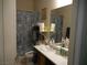 This bathroom features a vanity with sink, framed mirror, and a blue shower curtain with a seashell pattern at , North Las Vegas, NV 89031