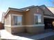 Tan one-story house with a two-car garage and landscaped yard at , North Las Vegas, NV 89031