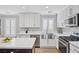 Modern white kitchen with stainless steel appliances and quartz countertops at 10278 Ladybug Bend St, Las Vegas, NV 89183