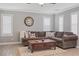 Living room with L-shaped sectional sofa and wood coffee table at 10278 Ladybug Bend St, Las Vegas, NV 89183