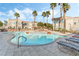 Community pool with a spa and lounge chairs at 10550 W Alexander Rd # 2026, Las Vegas, NV 89129