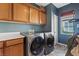 Laundry room with washer, dryer, and ample cabinet storage at 10712 Sheepshead Bay Ave, Las Vegas, NV 89166