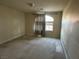 Bright bedroom featuring an arched window and neutral wall tones at 10973 Inverlochy Ct, Las Vegas, NV 89141