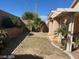 Landscaped backyard with patio cover and grassy area at 2113 Diamond Brook Ct, Las Vegas, NV 89117