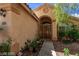 House exterior with arched entryway and landscaping at 2113 Diamond Brook Ct, Las Vegas, NV 89117